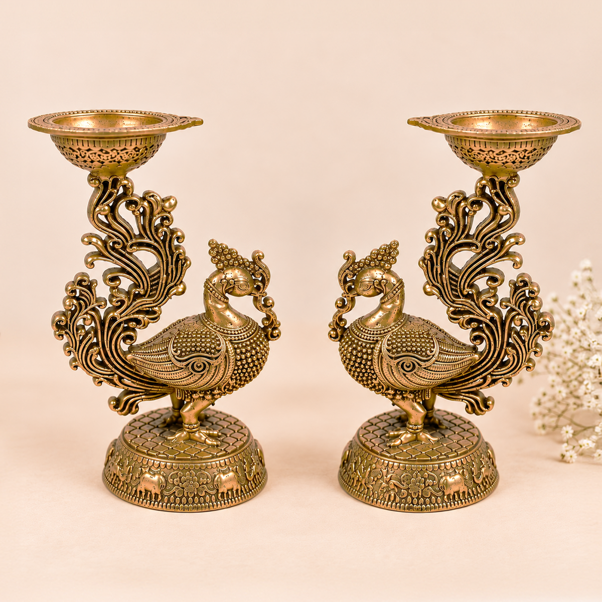 Pair of handcrafted brass peacock diya lamps from Kaari Tales, traditional oil lamps for puja, festive decor, and gifting.