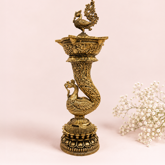 Handcrafted brass peacock deepam oil lamp by Kaari Tales, traditional home decor for puja, festivities, and gifting.